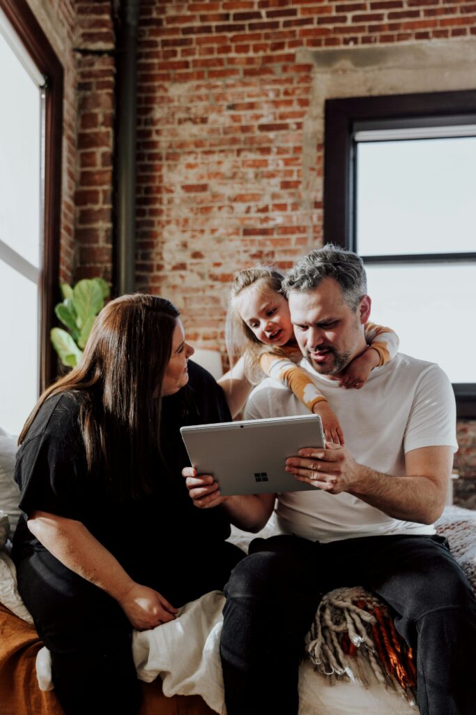 Man, woman and child looking at a tablet